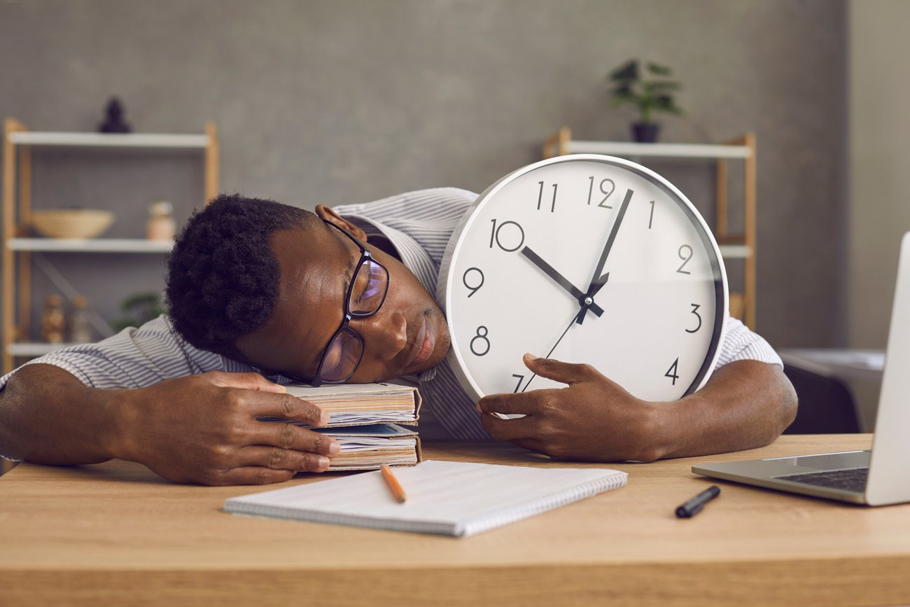 Exhausted Black Man Sleeping at His Desk